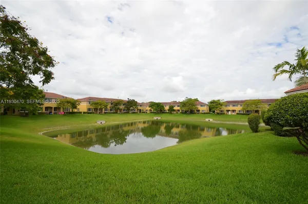 a view of a lake with houses in the back