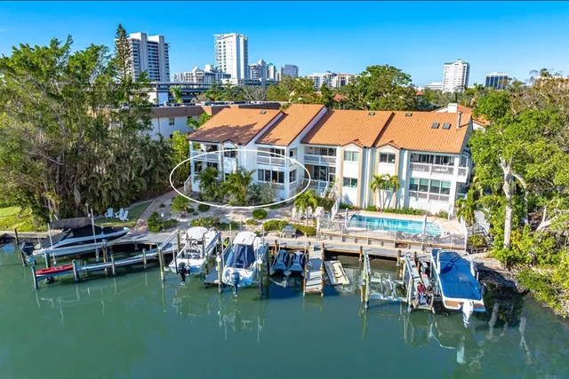 a aerial view of a house with swimming pool garden view and a chairs