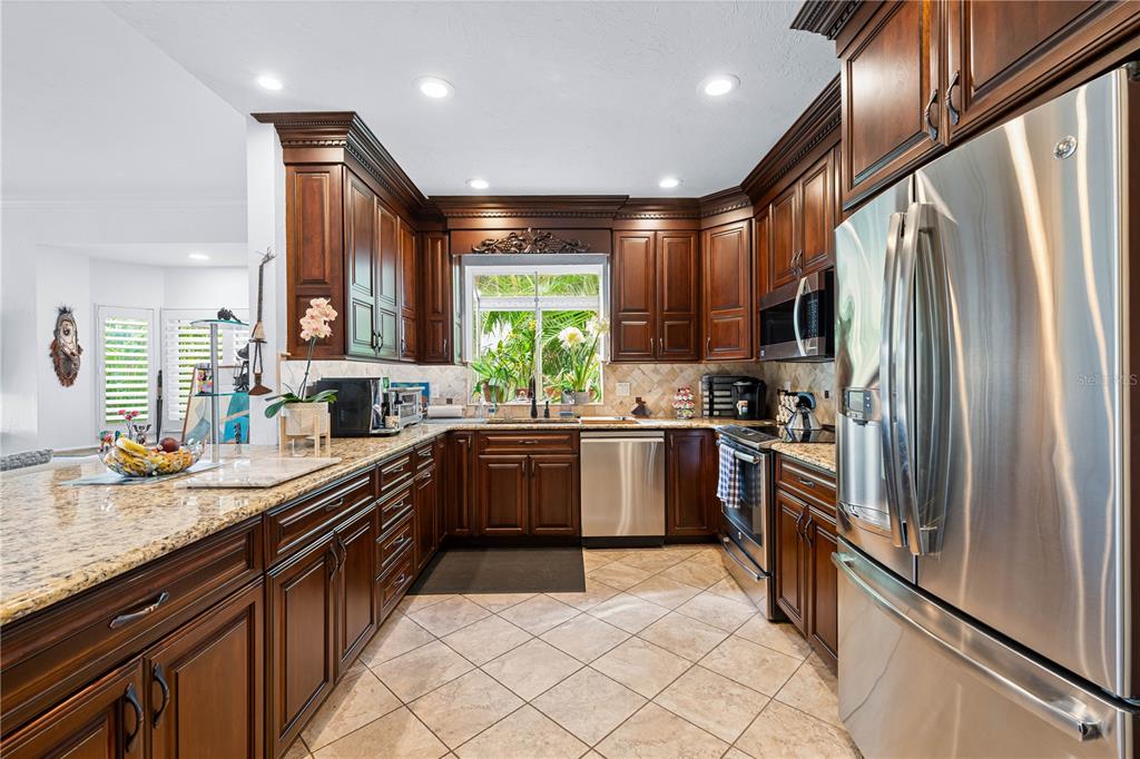 866 Hudson Avenue, Unit 866 Sarasota, FL 34236 - Photo 14 of 38 a kitchen with stainless steel appliances granite countertop a refrigerator a sink dishwasher a stove and a refrigerator