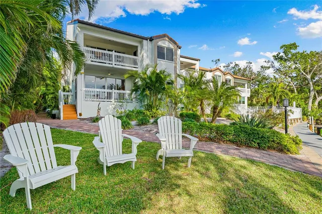 a front view of a house with a yard table and chairs