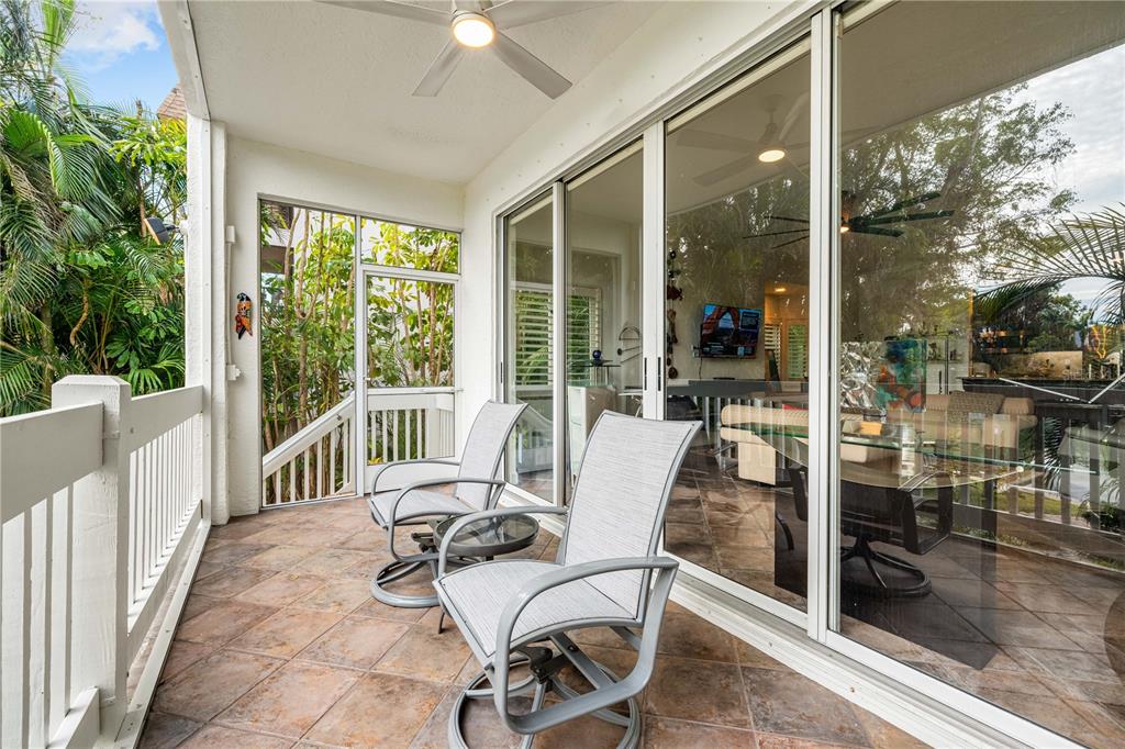 866 Hudson Avenue, Unit 866 Sarasota, FL 34236 - Photo 30 of 38 a view of a patio with a dining table and chairs