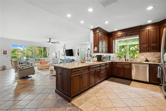 a kitchen with stainless steel appliances granite countertop a stove and a sink