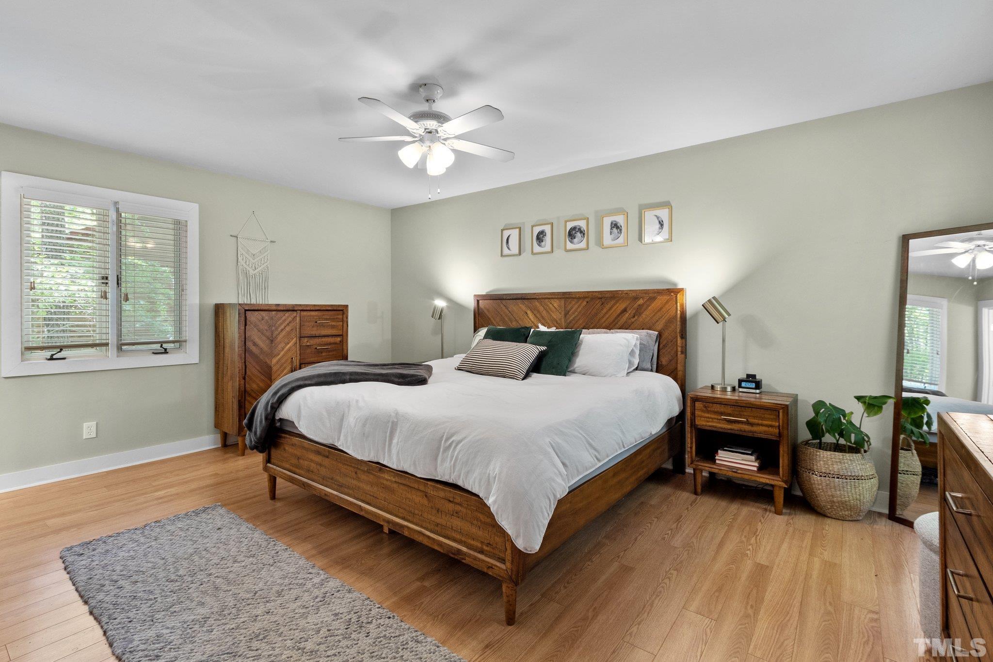 5 St James Court Durham, NC 27713 - Photo 21 of 44 a bedroom with a bed and a chandelier