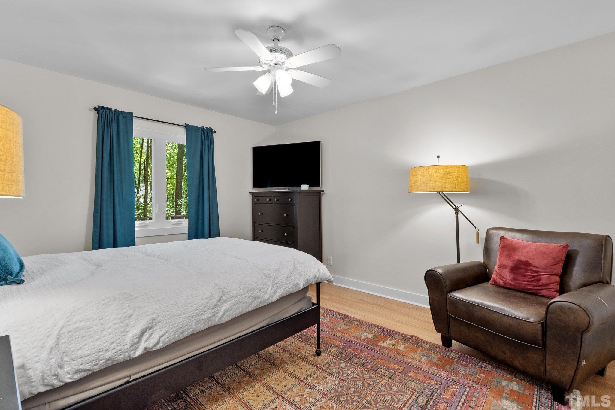 5 St James Court Durham, NC 27713 - Photo 24 of 44 a bedroom with a bed and a chandelier