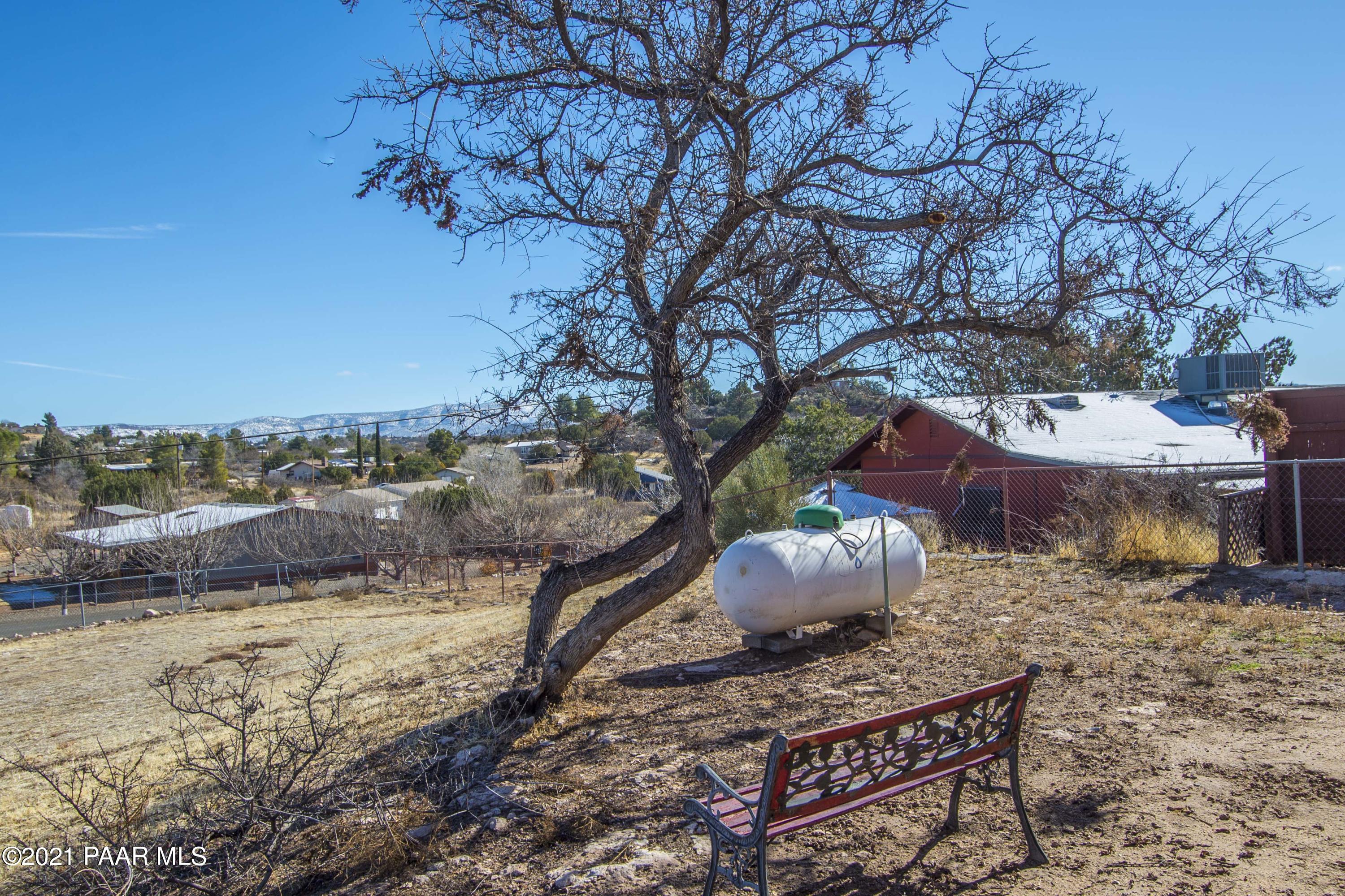 4650 Quail Hollow Road Rimrock, AZ 86335 - Photo 33 of 36 a wooden bench sitting in the middle of a yard