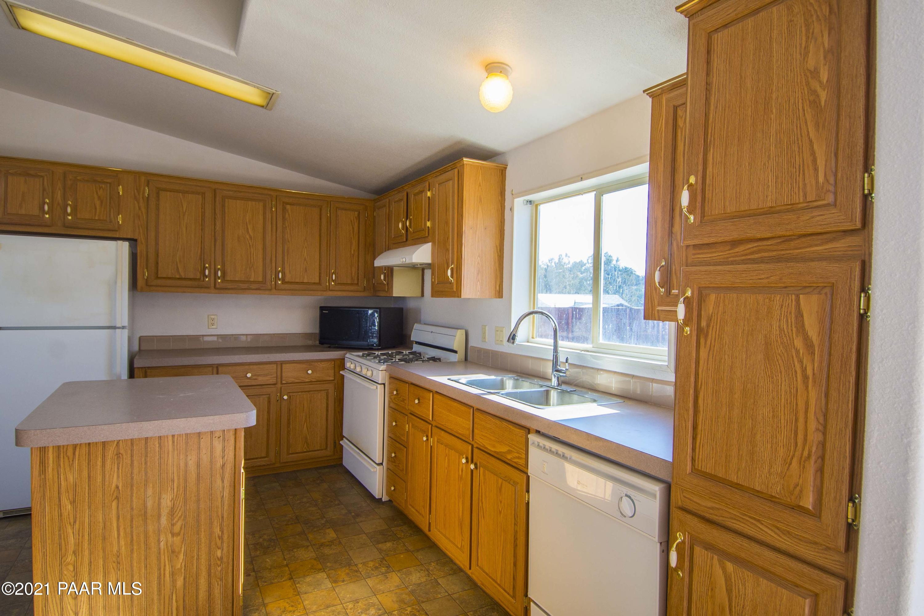 4650 Quail Hollow Road Rimrock, AZ 86335 - Photo 4 of 36 a kitchen with a sink a counter top space cabinets and a window