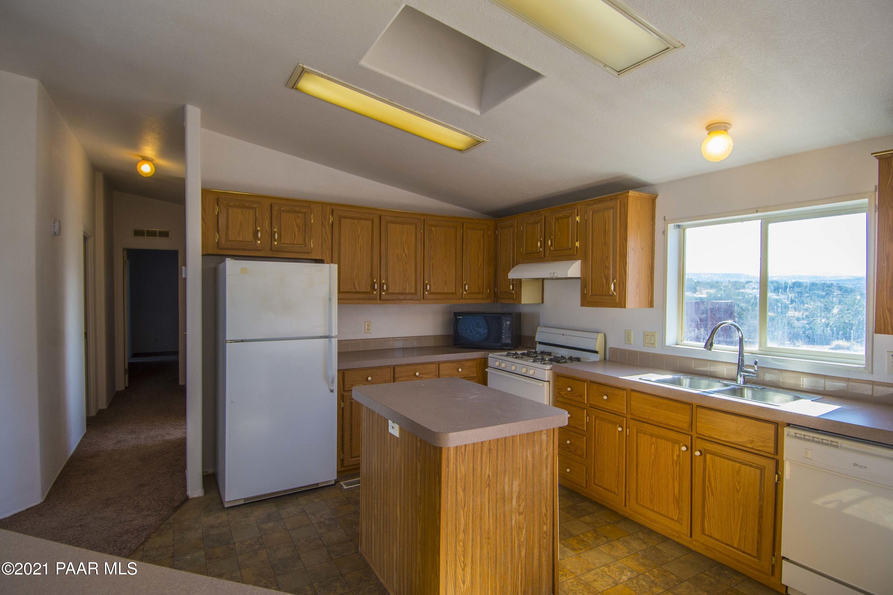 4650 Quail Hollow Road Rimrock, AZ 86335 - Photo 6 of 36 a kitchen with a refrigerator a sink and cabinets