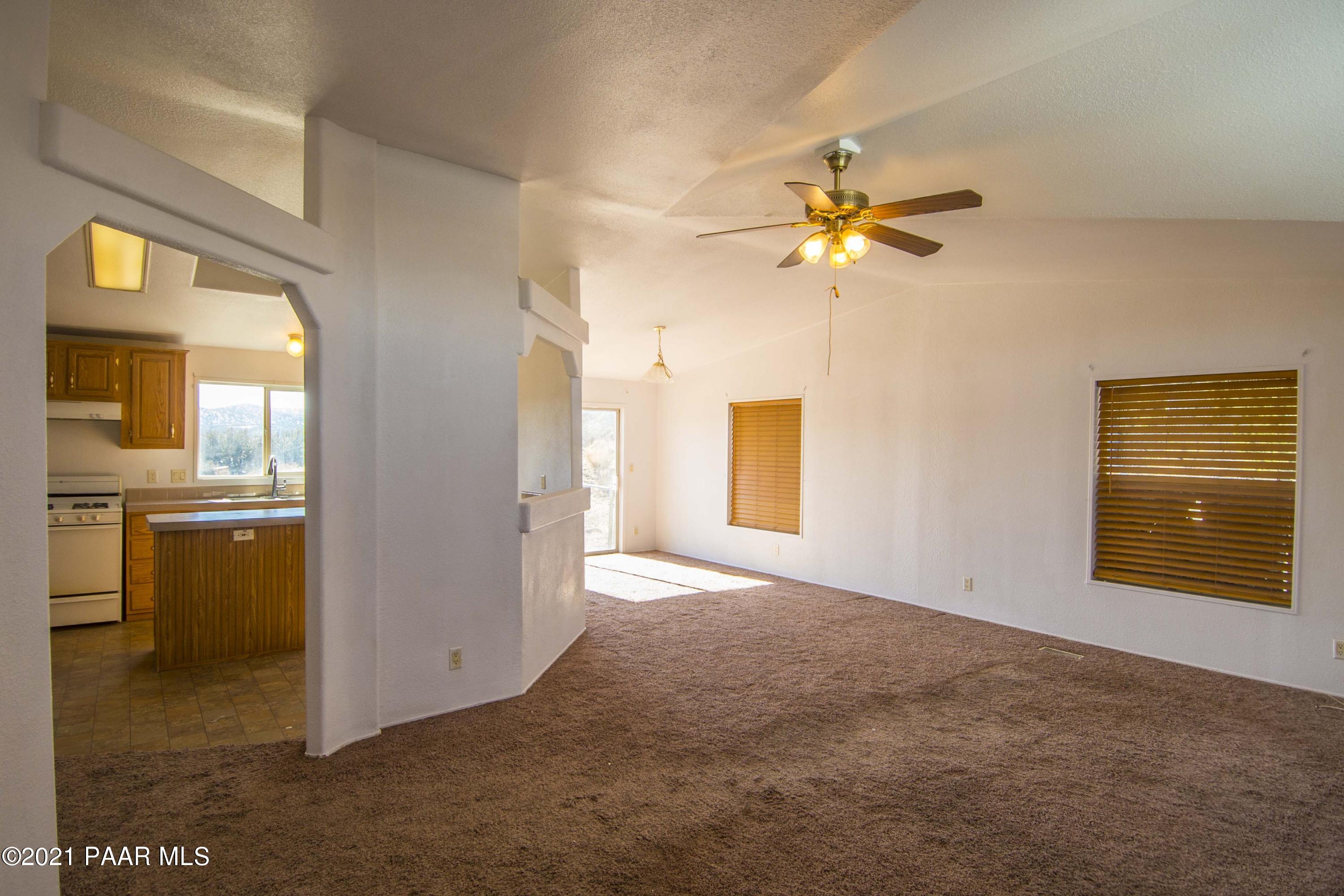 4650 Quail Hollow Road Rimrock, AZ 86335 - Photo 8 of 36 a view of a kitchen with a sink and a chandelier fan