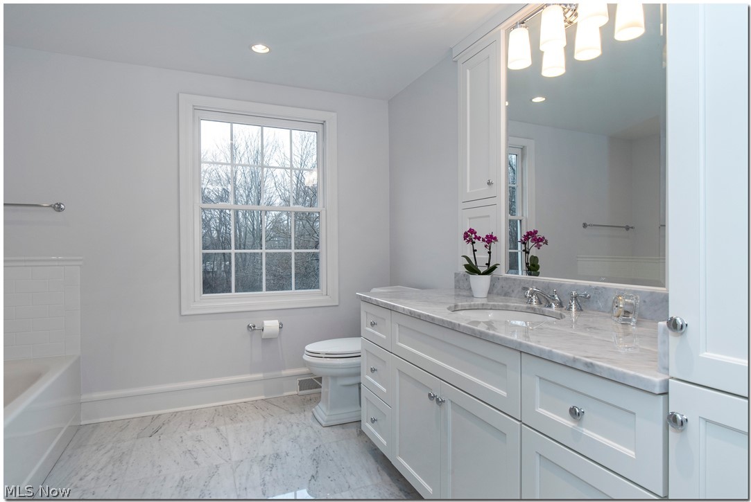30049 Bryce Road Cleveland, OH 44124 - Photo 17 of 27 The marble-clad owners' bath is classically appointed with white cabinetry and chrome fixtures.