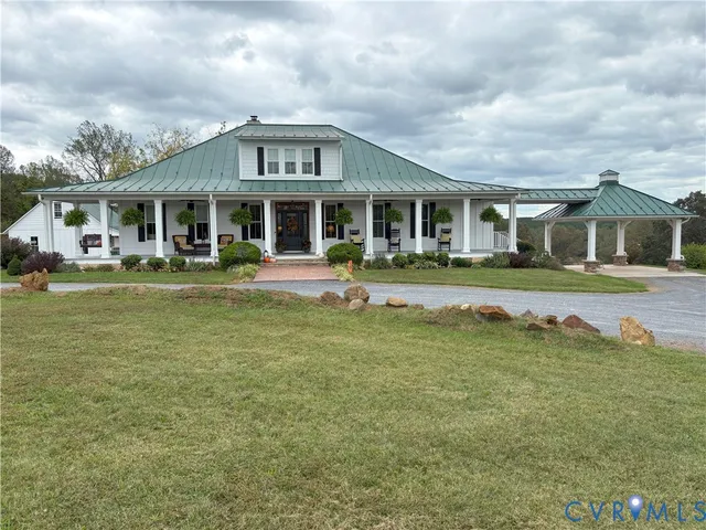 a front view of a house with a garden and trees