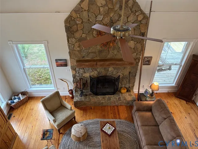 a view of a balcony with chairs and wooden floor