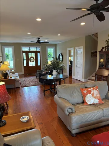 a living room with furniture and wooden floor