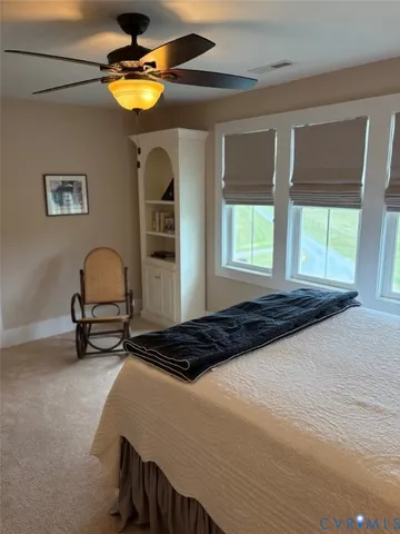 a bedroom with a bed and a lamp