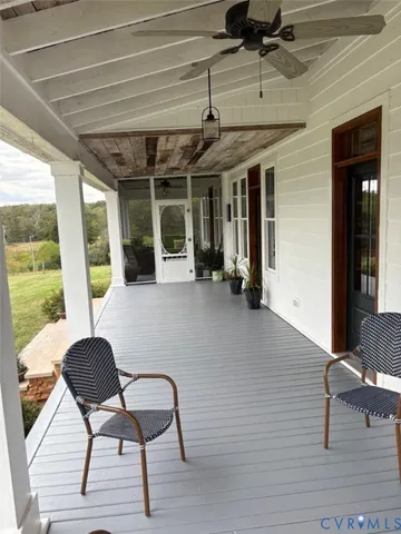 a living room with furniture and a mirror
