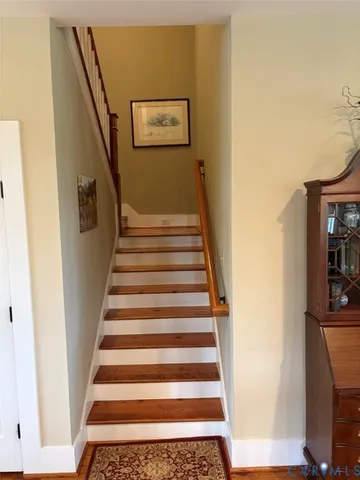 a view of a patio with table and chairs with a floor to ceiling window and potted plants