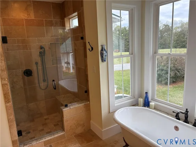 a bathroom with a tub and a shower