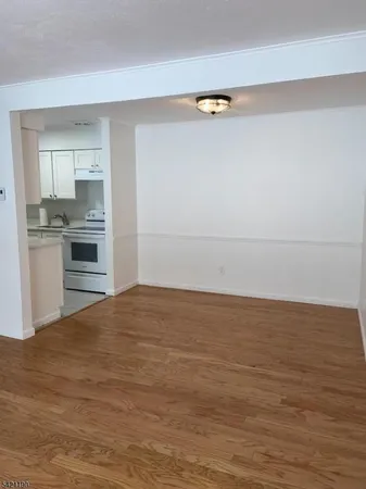 a view of kitchen and empty room