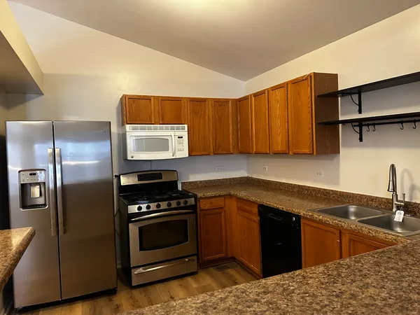 a kitchen with a sink stove and refrigerator