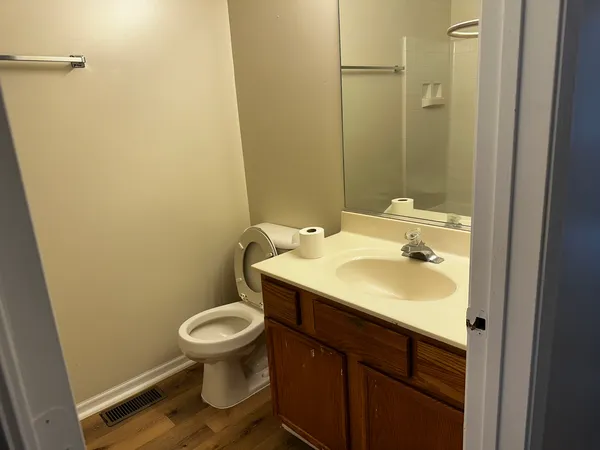 a bathroom with a sink toilet and a mirror