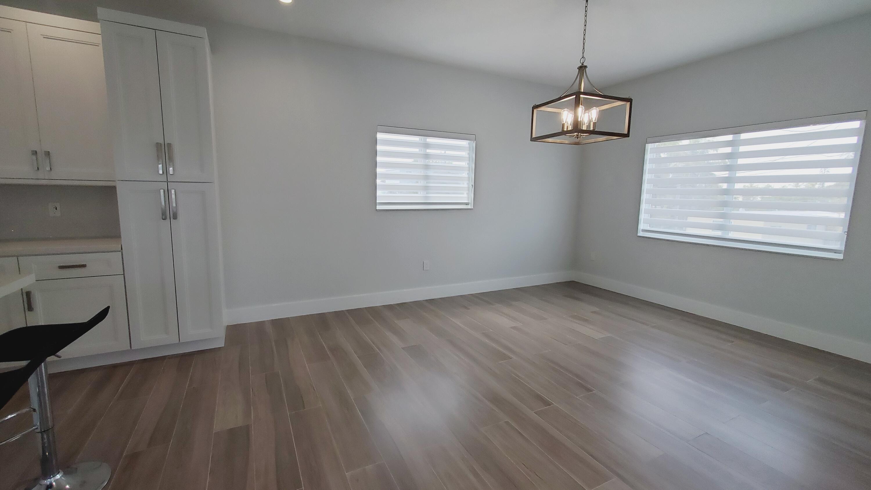 554 Gordon Circle Key Largo, FL 33037 - Photo 11 of 36 a view of an empty room with wooden floor and a window