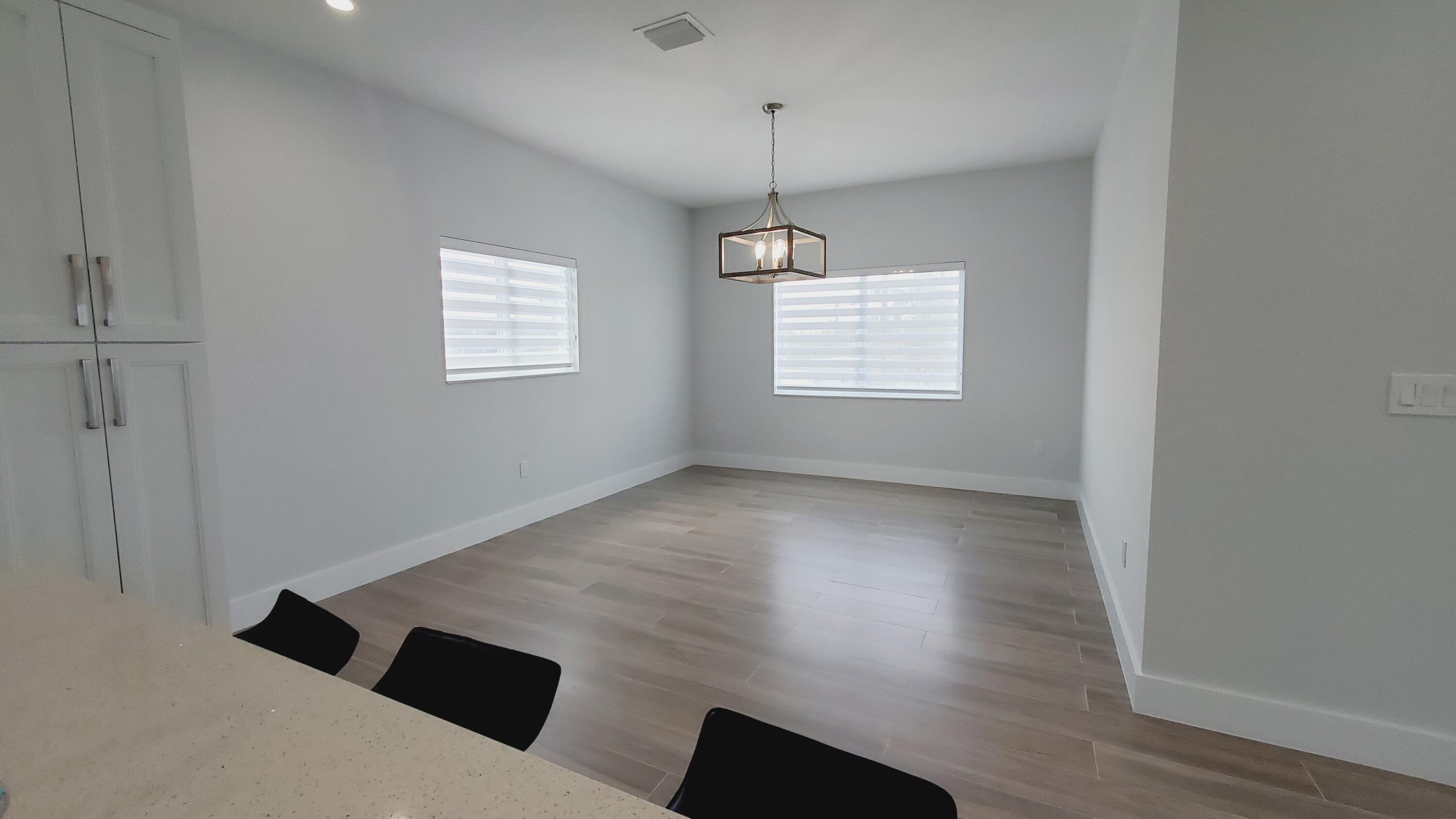 554 Gordon Circle Key Largo, FL 33037 - Photo 15 of 36 a view of an empty room with wooden floor and a window