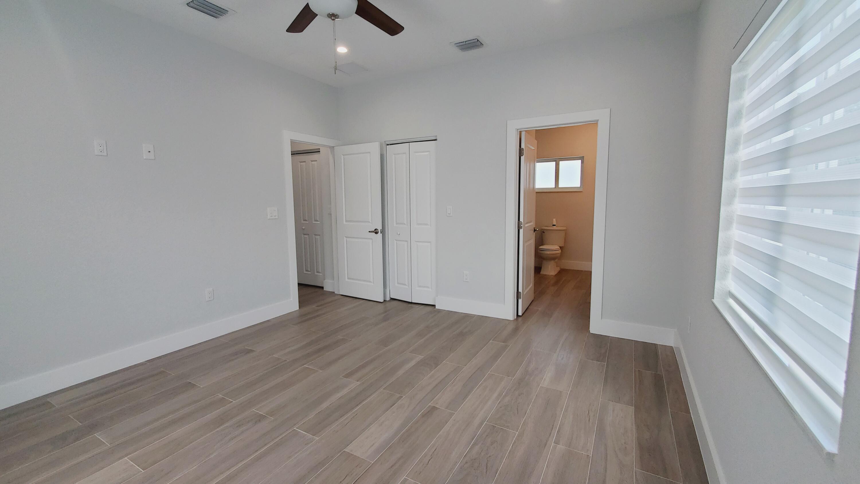 554 Gordon Circle Key Largo, FL 33037 - Photo 21 of 36 a view of an empty room with wooden floor and a window