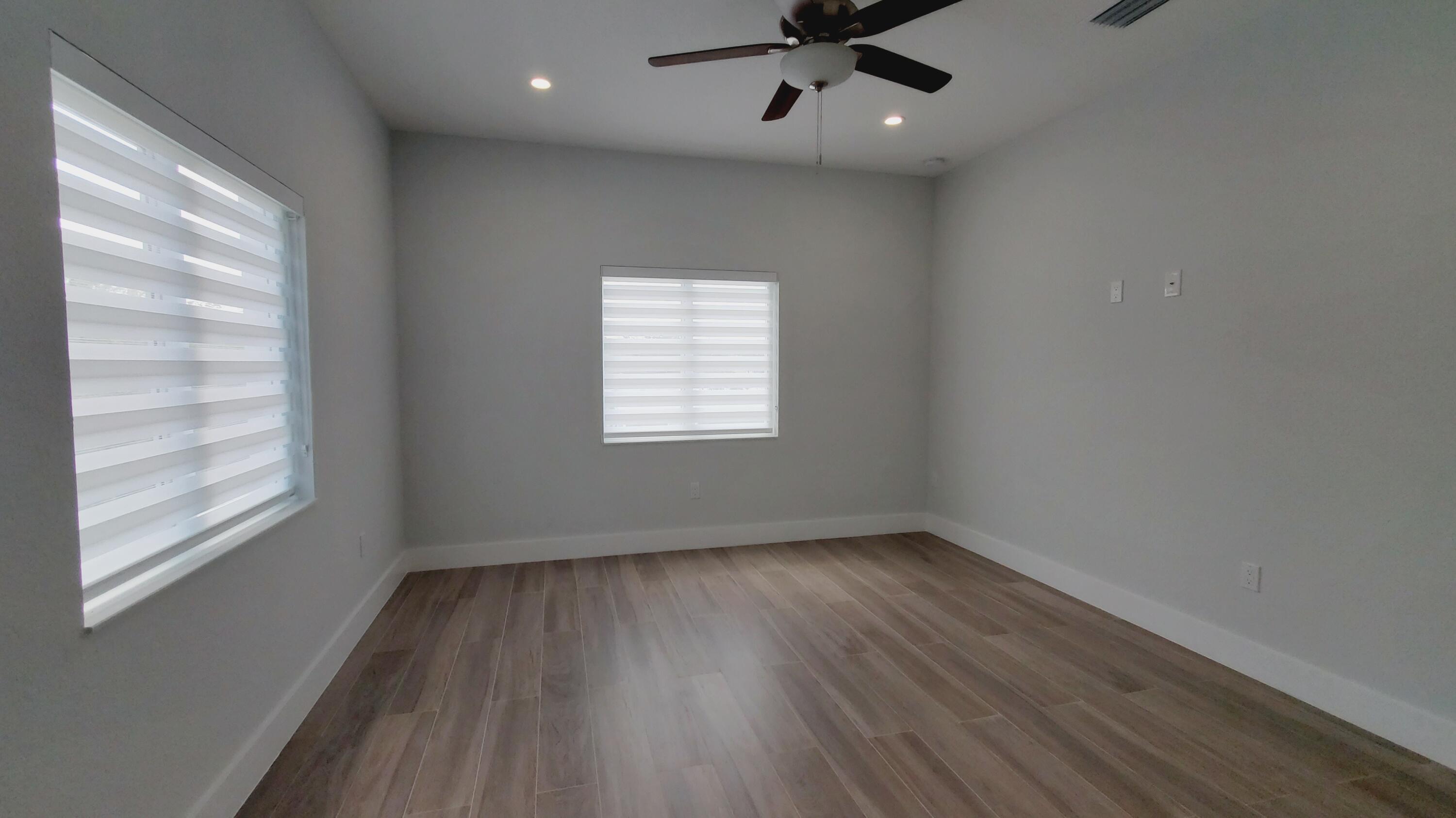 554 Gordon Circle Key Largo, FL 33037 - Photo 23 of 36 an empty room with a window and wooden floor