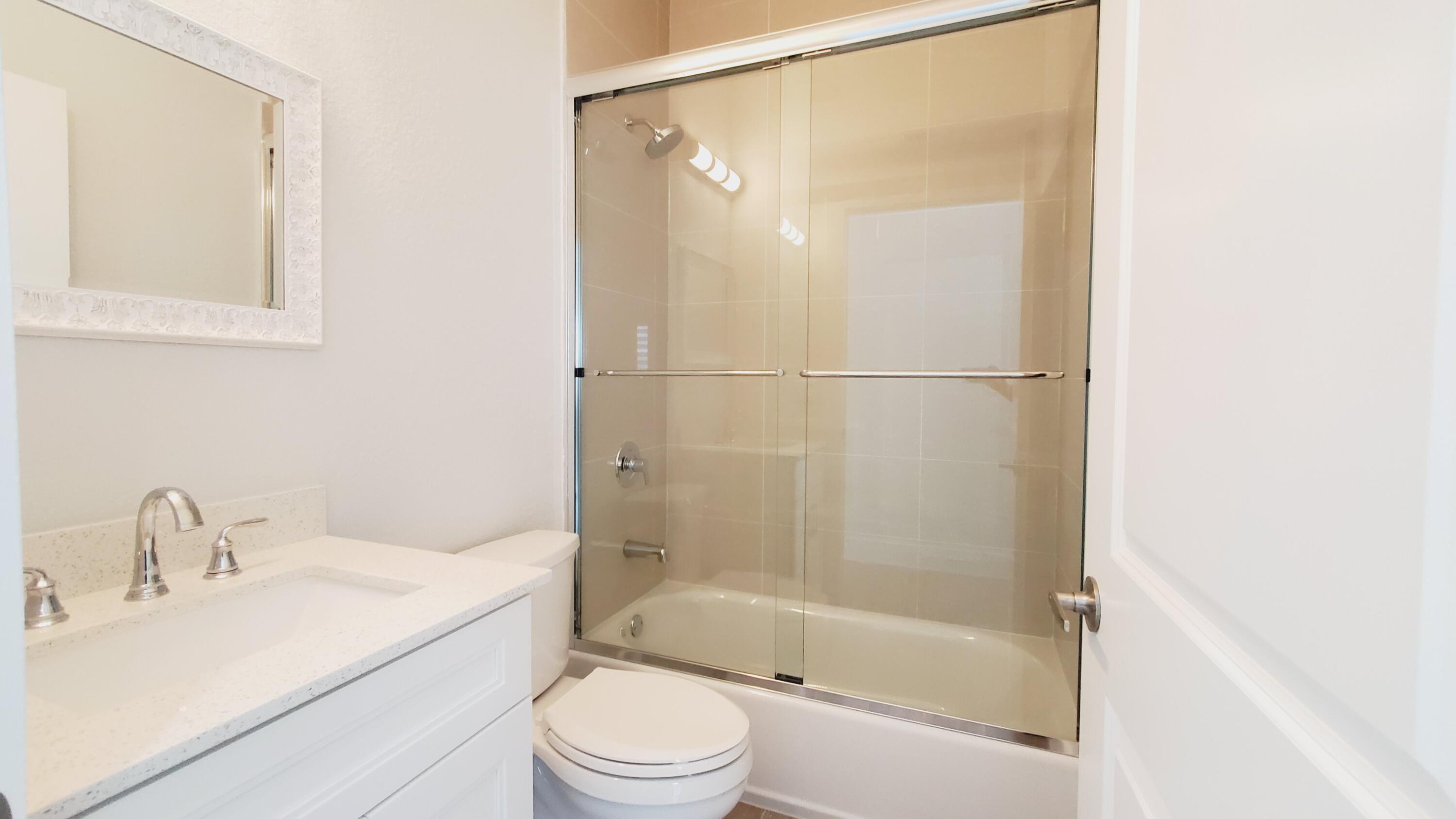 554 Gordon Circle Key Largo, FL 33037 - Photo 24 of 36 a bathroom with a bathtub shower sink mirror and toilet