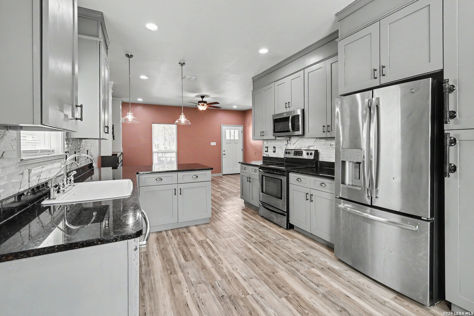 2071 Hornsby Spring Branch, TX 78070 - Photo 11 of 20 a kitchen with a refrigerator a sink and dishwasher with wooden floor