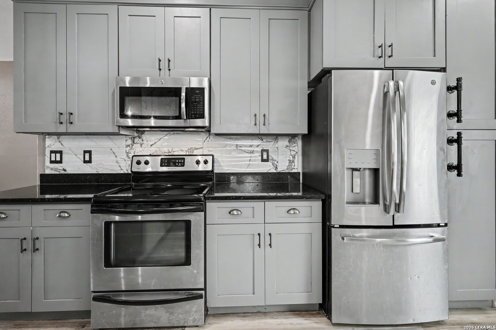 2071 Hornsby Spring Branch, TX 78070 - Photo 12 of 20 a kitchen with stainless steel appliances white cabinets white stove a microwave and a refrigerator