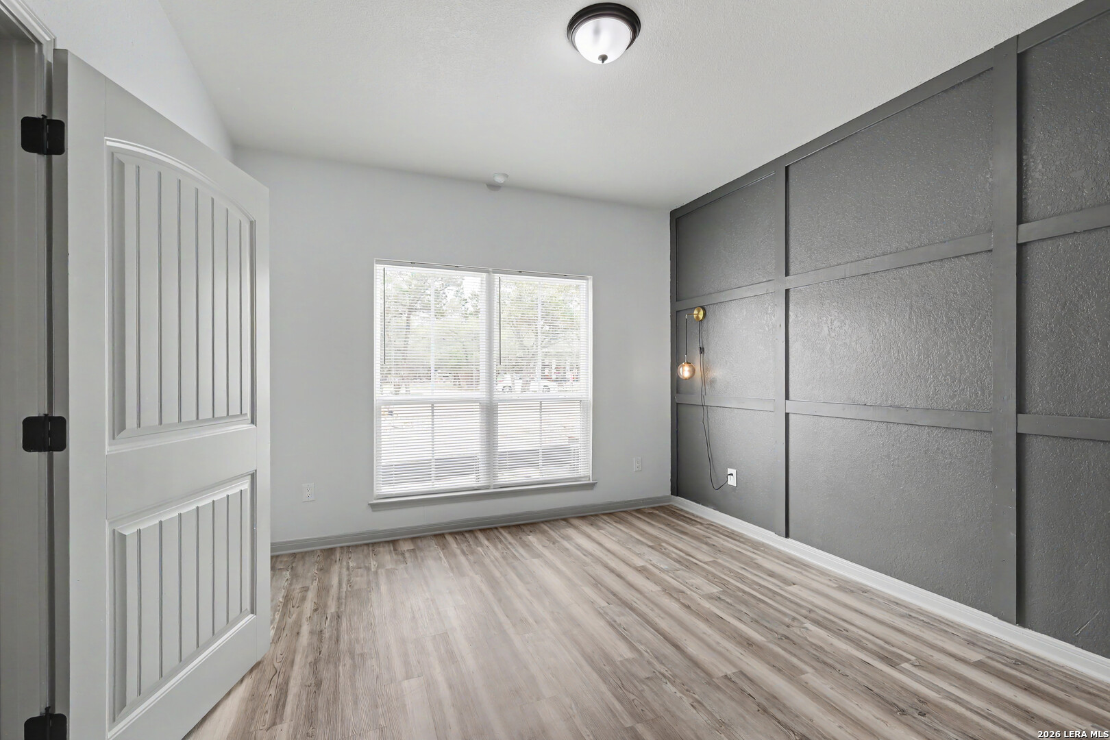 2071 Hornsby Spring Branch, TX 78070 - Photo 14 of 20 a view of an empty room with wooden floor and a window