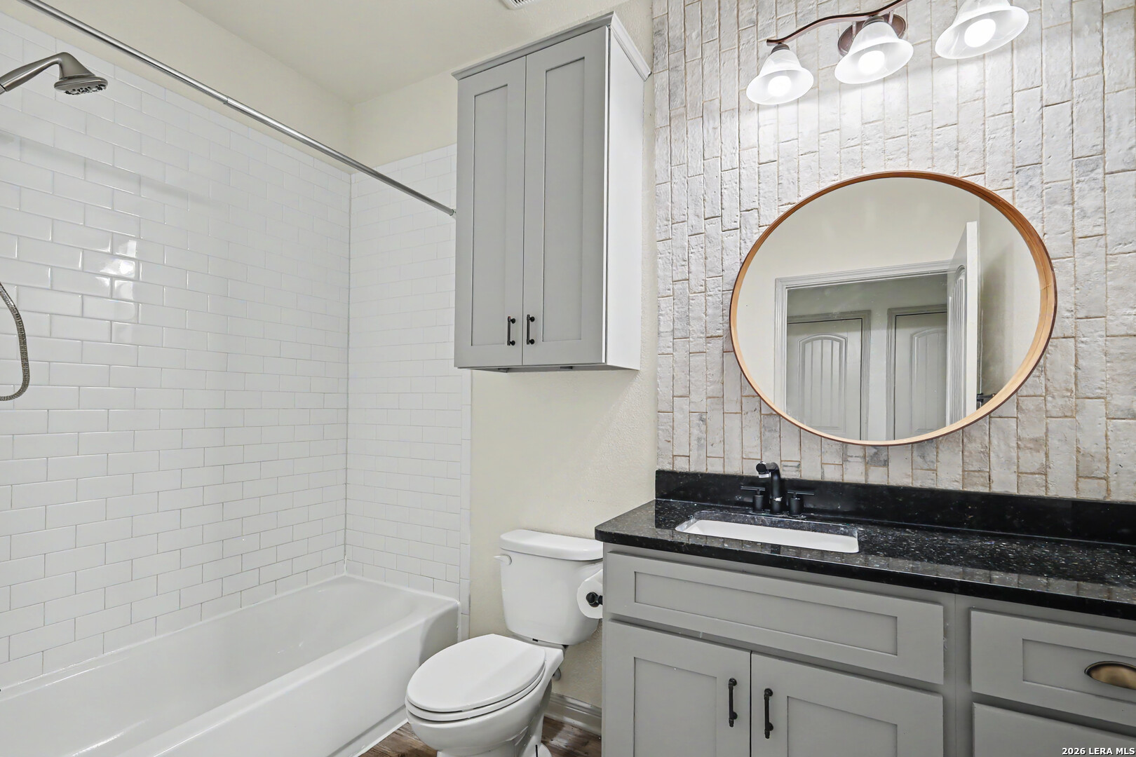2071 Hornsby Spring Branch, TX 78070 - Photo 17 of 20 a bathroom with a granite countertop toilet a sink and a mirror