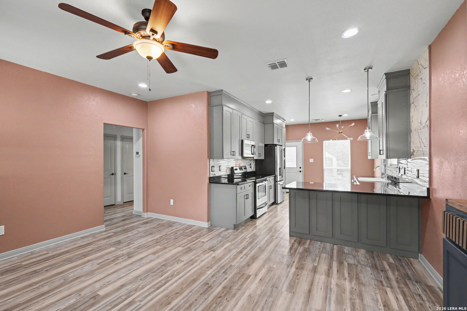 2071 Hornsby Spring Branch, TX 78070 - Photo 6 of 20 a large kitchen with stainless steel appliances granite countertop a lot of counter space and wooden floor