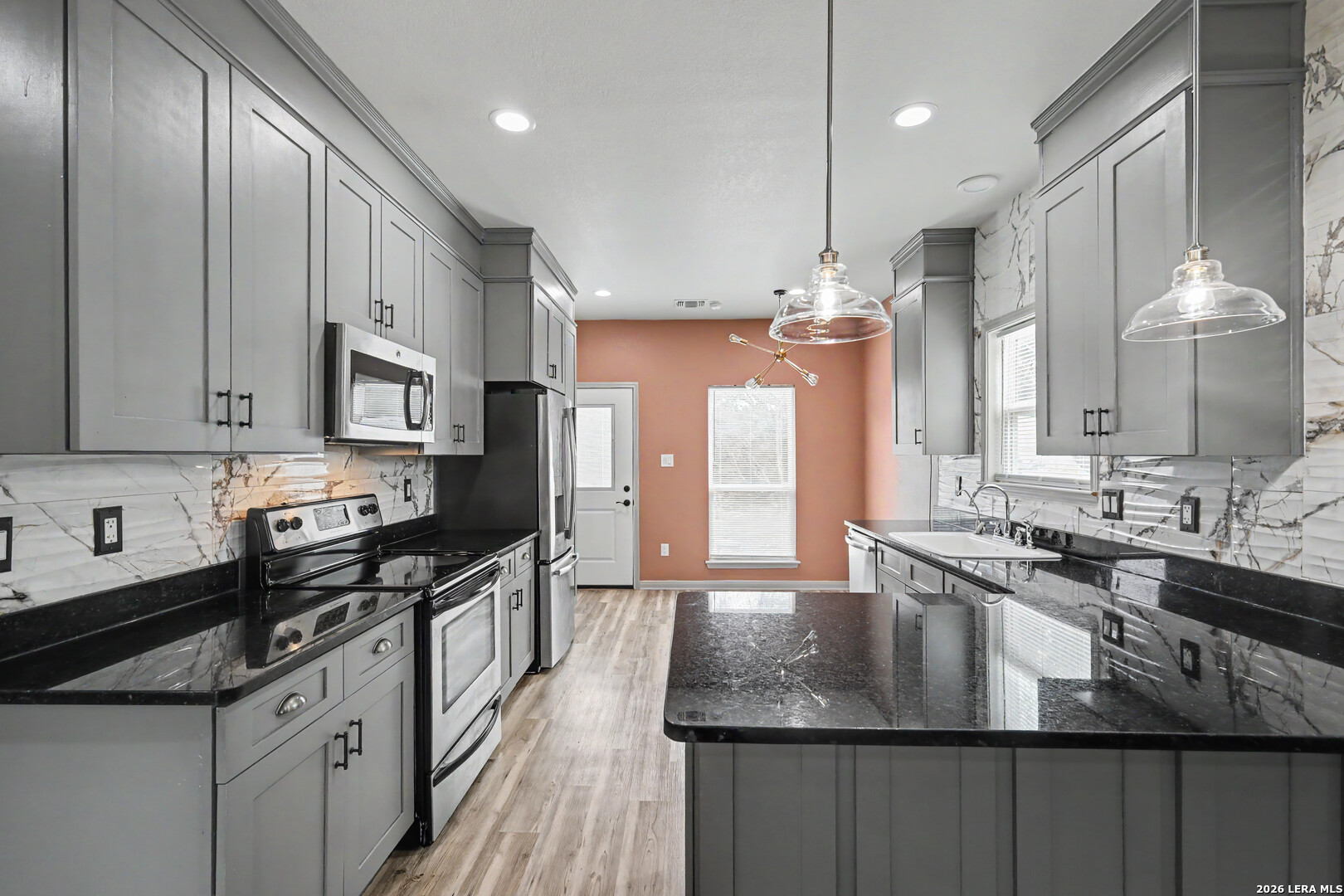 2071 Hornsby Spring Branch, TX 78070 - Photo 7 of 20 a kitchen with stainless steel appliances granite countertop a sink a stove and a refrigerator