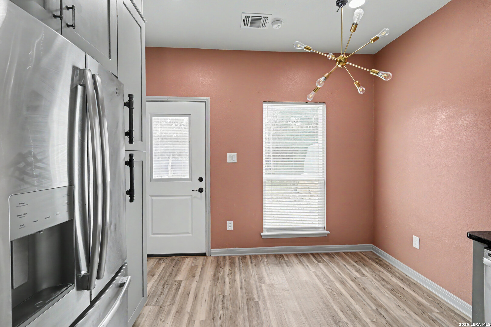 2071 Hornsby Spring Branch, TX 78070 - Photo 8 of 20 a view of an empty room with window and wooden floor