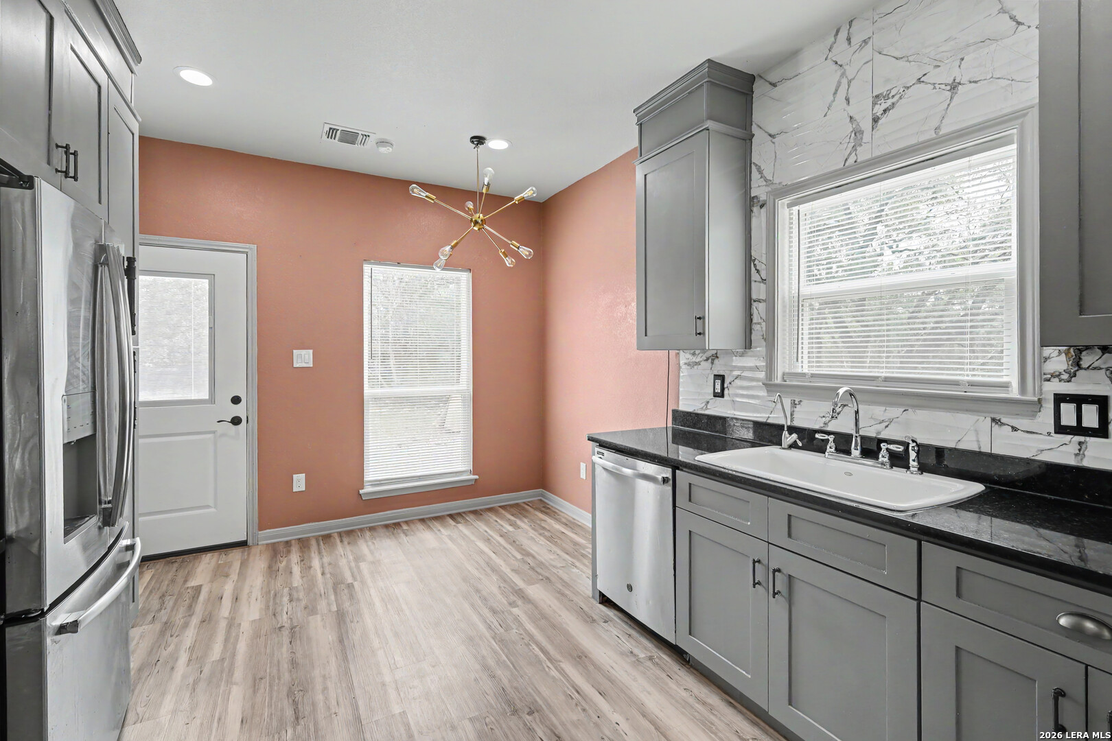 2071 Hornsby Spring Branch, TX 78070 - Photo 9 of 20 a kitchen with a sink wooden floor and a large window