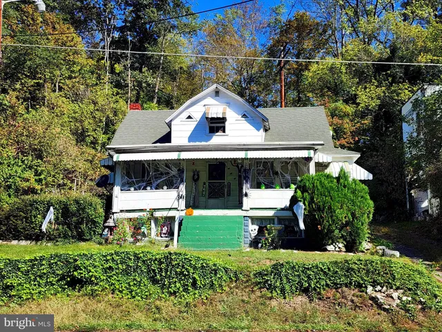 a aerial view of a house with a yard and sitting area