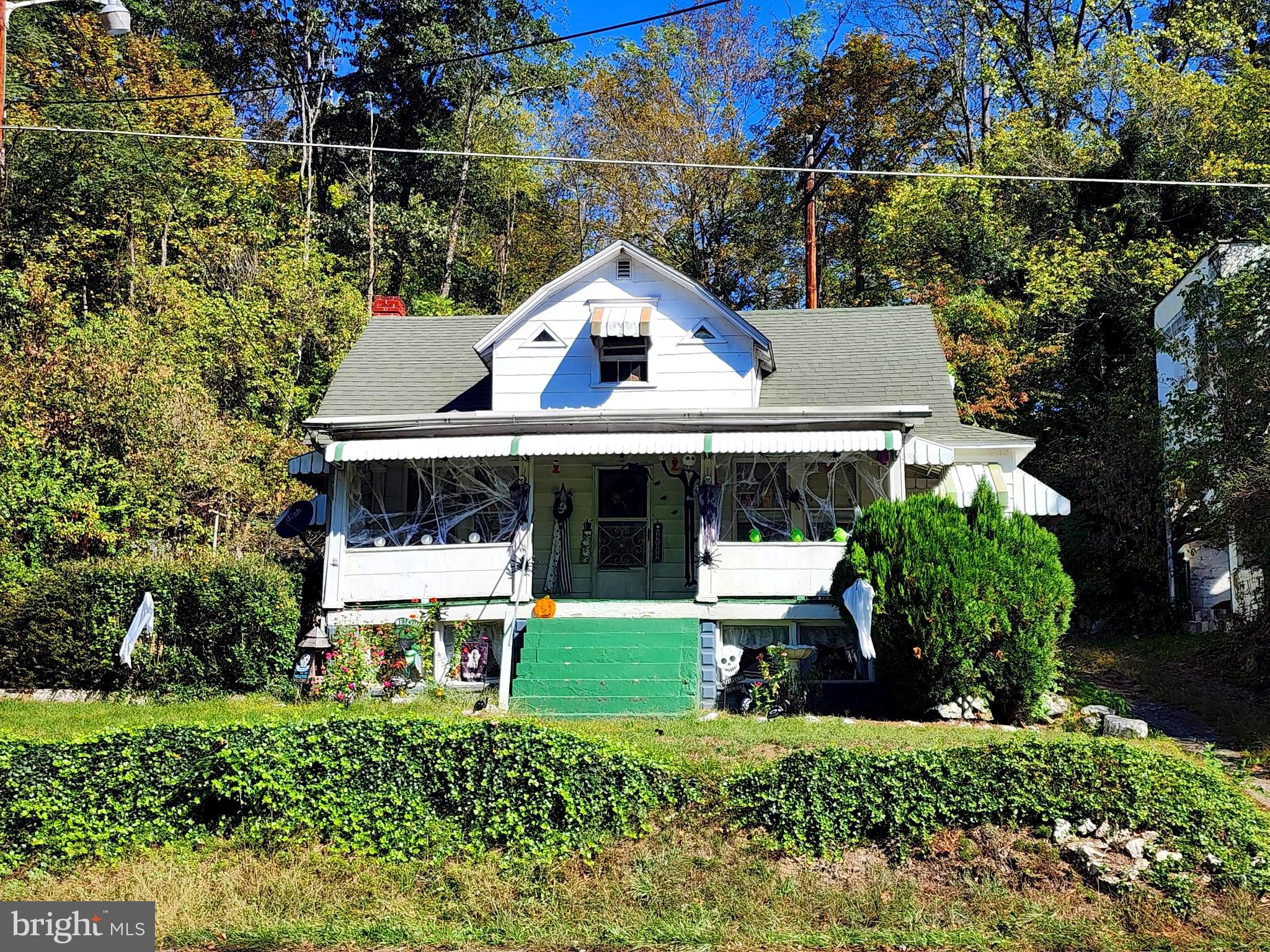 a aerial view of a house with a yard and sitting area