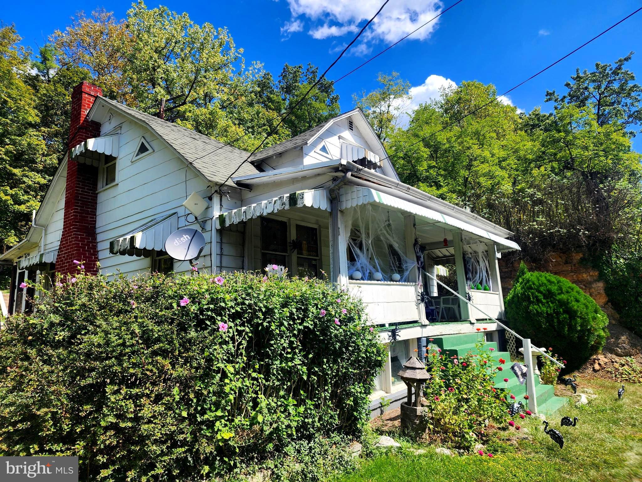 13214 Oldtown Road Southeast Cumberland, MD 21502 - Photo 3 of 15 a front view of a house with garden