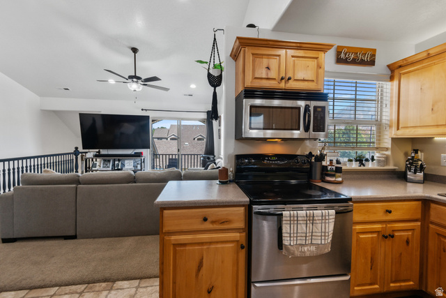 2515 West 450 South, Unit 2 Springville, UT 84663 - Photo 7 of 21 Kitchen featuring light wood cabinetry, stainless steel microwave, black electric range, and gray countertops