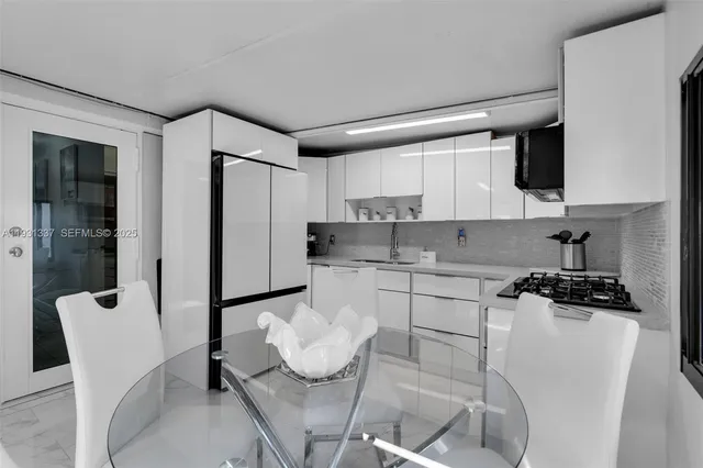 a kitchen with stainless steel appliances kitchen island granite countertop a sink and cabinets