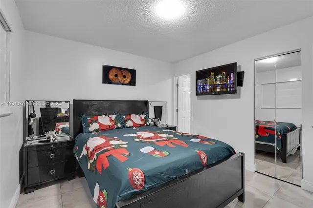 a bedroom with bed and a tv