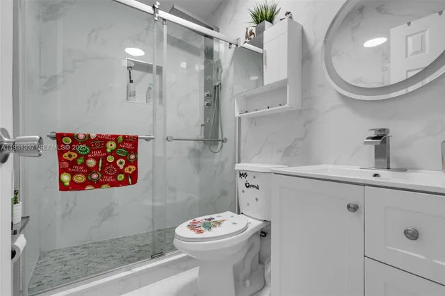 a bathroom with a sink mirror and toilet