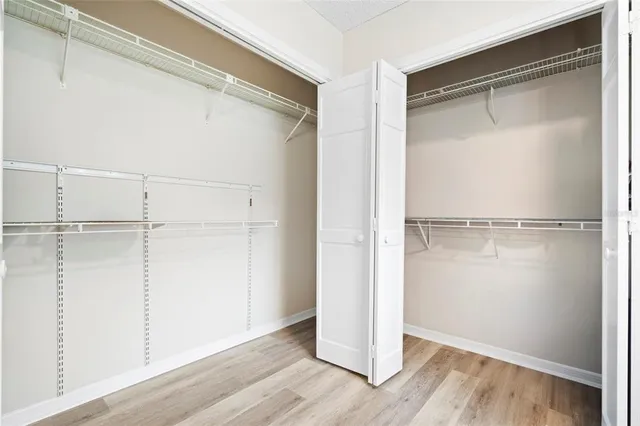 a view of a room with wooden floor