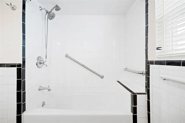 a bathroom with a bathtub and a shower