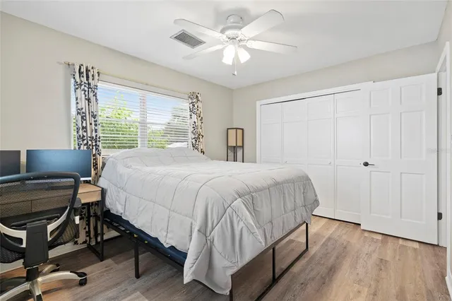 a bedroom with a bed and a table with chair