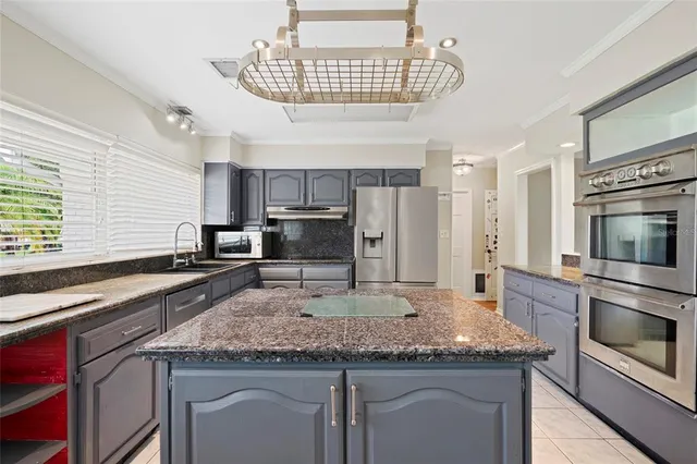 a kitchen with a center island and stainless steel appliances