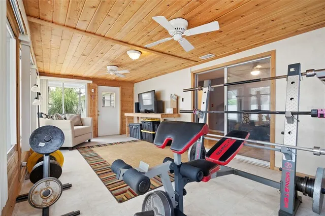 a living room with furniture a rug and white walls