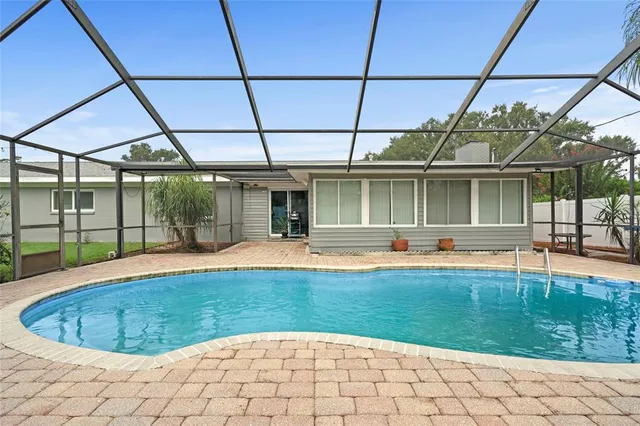 a view of a backyard patio with swimming pool