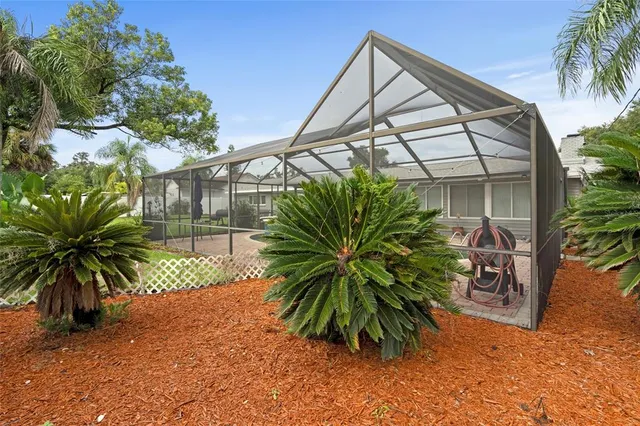 a view of a house with backyard sitting area and garden